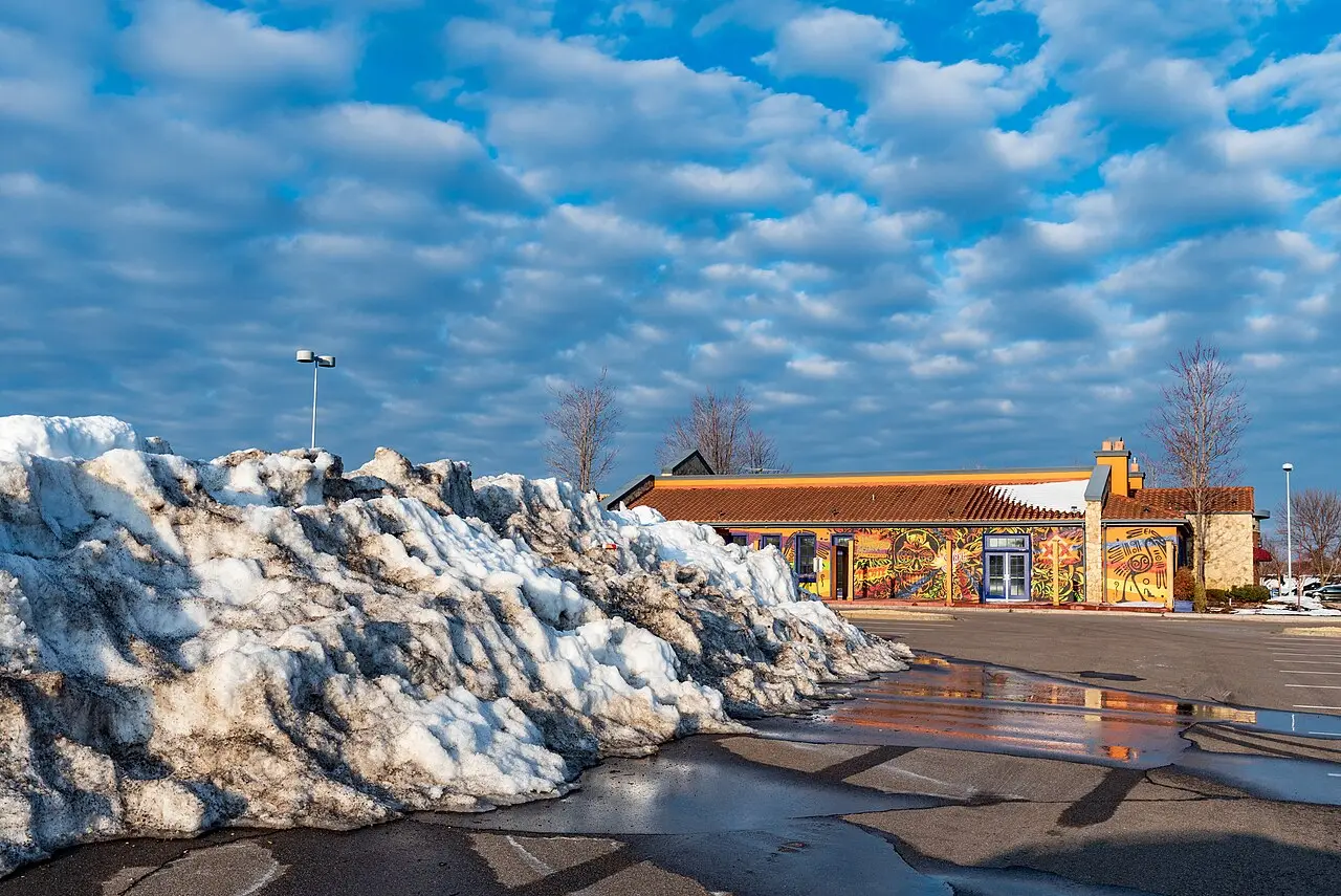 Plowed snow pile at the edge of a commercial parking lot, illustrating lake effect snow prep in Middletown